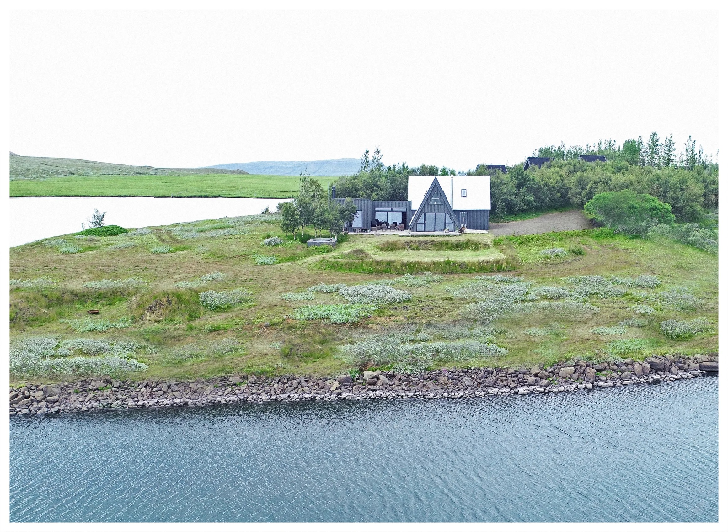 Aerial view of the home on its lakeshore peninsula