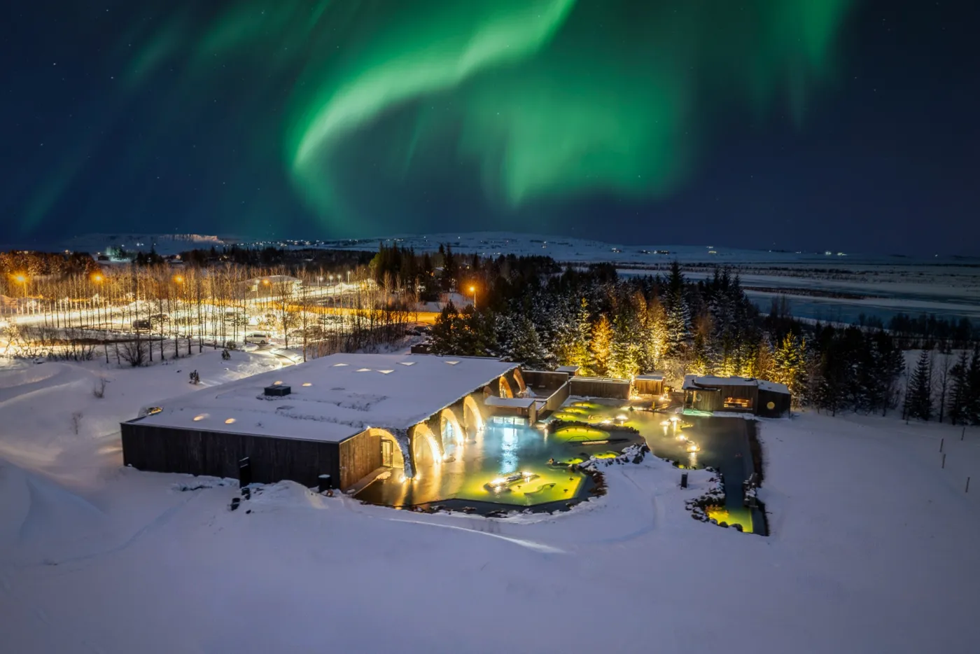 The northern lights over a geothermal lagoon